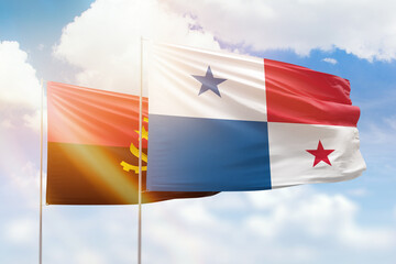 Sunny blue sky and flags of panama and angola
