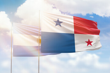 Sunny blue sky and flags of panama and argentina