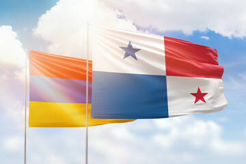 Sunny blue sky and flags of panama and armenia