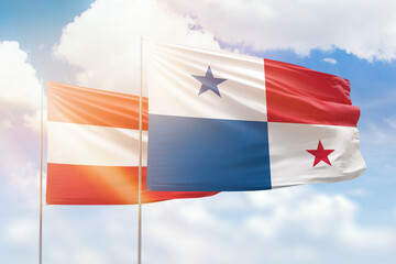 Sunny blue sky and flags of panama and austria