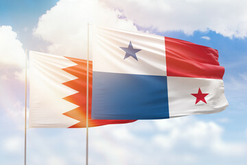 Sunny blue sky and flags of panama and bahrain