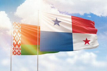 Sunny blue sky and flags of panama and belarus