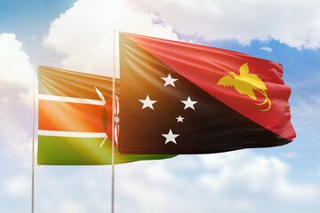 Sunny blue sky and flags of papua new guinea and kenya