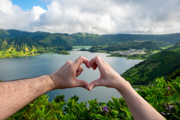 Man and Woman forming with heart shape with hands. Twin Lake - 