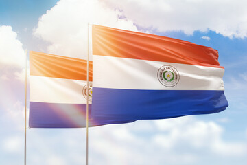 Sunny blue sky and flags of paraguay and paraguay