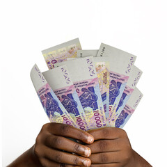 Black hands holding 3D rendered 10000 west African Cfa franc notes. closeup of Hands holding Cfa...