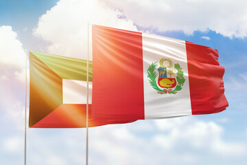 Sunny blue sky and flags of peru and kuwait