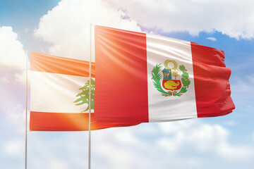 Sunny blue sky and flags of peru and lebanon