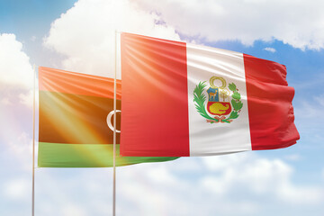 Sunny blue sky and flags of peru and libya