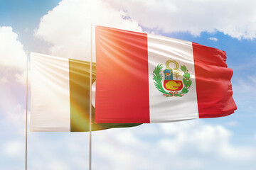 Sunny blue sky and flags of peru and pakistan
