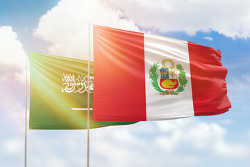 Sunny blue sky and flags of peru and saudi arabia