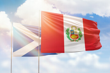 Sunny blue sky and flags of peru and scotland