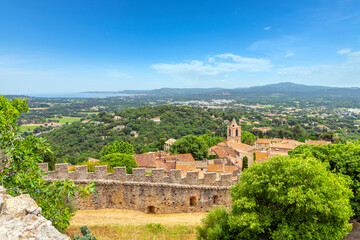 Fototapeta na wymiar View of the medieval village of Grimaud France from the Chateau de Grimaud with the countryside of the Provence region of France and the Mediterranean Sea in view above Saint-Tropez, France.