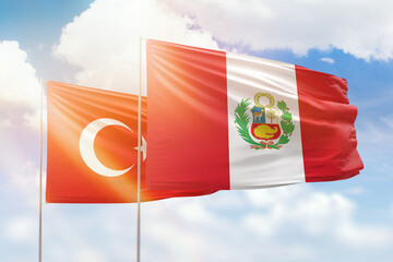 Sunny blue sky and flags of peru and turkey