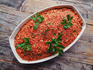 top view of Vegan meat or Mett as a spread - meat substitute made from rice cakes and tomato paste on wooden table in white bowl