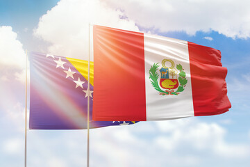 Sunny blue sky and flags of peru and bosnia