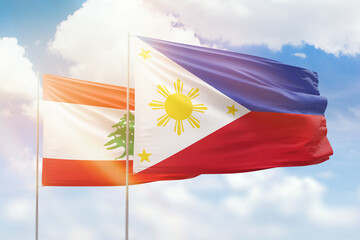 Sunny blue sky and flags of philippines and lebanon