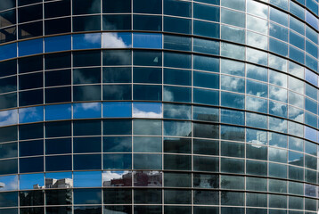 Naklejka na ściany i meble Reflection in the glass of the business center building