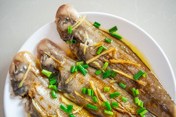 A plate of steamed longli fish on the table