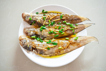 A plate of steamed longli fish on the table