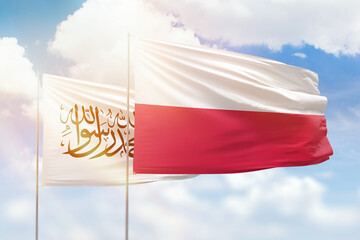 Sunny blue sky and flags of poland and afghanistan