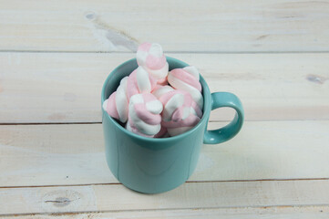 sweet pink marshmallows on a wooden floor