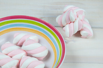 sweet pink marshmallows on a wooden floor
