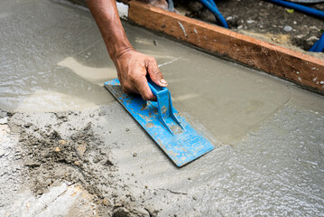 Worker Leveling and Flattening Concrete on Reparing Street. Contruction Concept