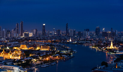 Fototapeta na wymiar Cityscape of Bangkok at Twilight with View of Grand Palace and Chao Phraya River From Above
