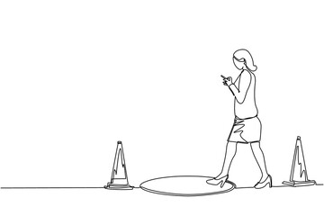 Single continuous line drawing businesswoman character going on street watching by smart phone, did not see open manhole. Woman walks to business trap. One line draw graphic design vector illustration