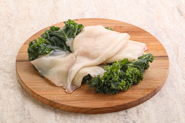 Raw squid over wooden board