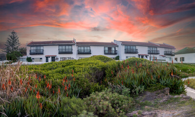 Fototapeta na wymiar Beautiful panoramic view of a sunset of the South African city of Hermanus, one of the southernmost cities in Africa and one of the places where whales can be observed.