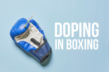 Blue boxing gloves close up. Concept - doping in sport on blue backgraund. Text-Doping in boxing - obrazy, fototapety, plakaty