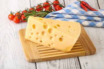 Maasdam cheese piece over board