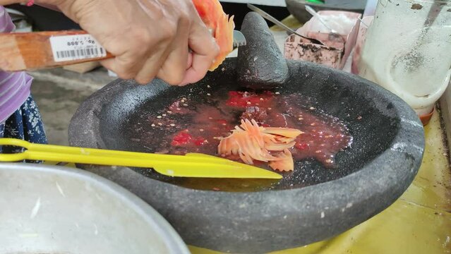 Indonesian food Rujak traders are slicing fruit. Rujak is a typical Indonesian food, consisting of fresh fruits and spicy spices.