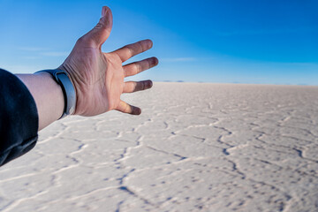 reaching out in the largest salt flat in the world, salar de uyuni bolivia