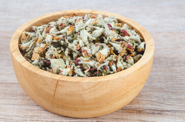 Flower tea. Dried of apple blossom in wooden bowl.