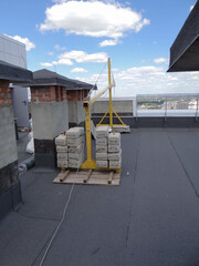 fixing a construction lift on the roof of a building.concrete counterweight.