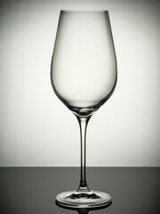 An empty champagne glass stands on a gray table