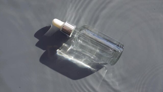 serum bottle in water with falling drops