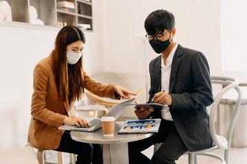 Kind leader executive manager share and discuss business solutions plan ideas on tablet with Asian female marketing manager