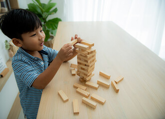 Dominoes arranged by boy's hand Boy builds tall wooden dominoes that risk falling. Stop Loss idea...
