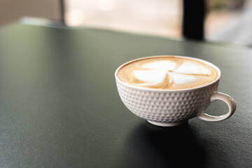 Coffee latte art ready to drink in a bright morning