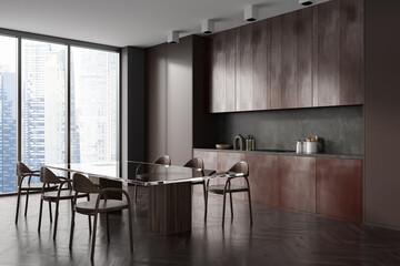 Stylish kitchen interior with eating table and chairs, panoramic window