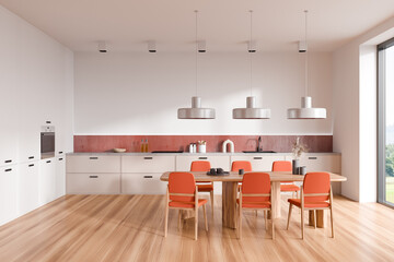 Light kitchen interior with eating table and seats, appliances and window