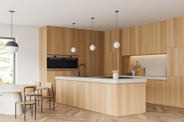 Light kitchen interior with countertop, eating area and panoramic window