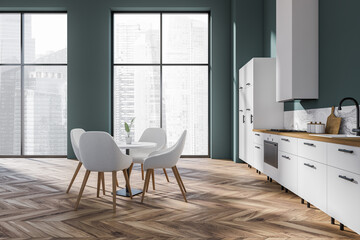 Blue kitchen interior with eating table and chairs near panoramic window