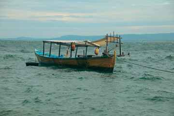 Traditional khmer wooden fishing boat moored at sea during the rainy season in Koh Sdach Island in Cambodia