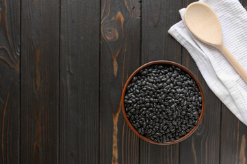 Fresh organic natural beans on wooden rustic black background
