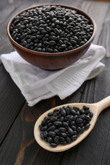 Fresh organic natural beans on wooden rustic black background